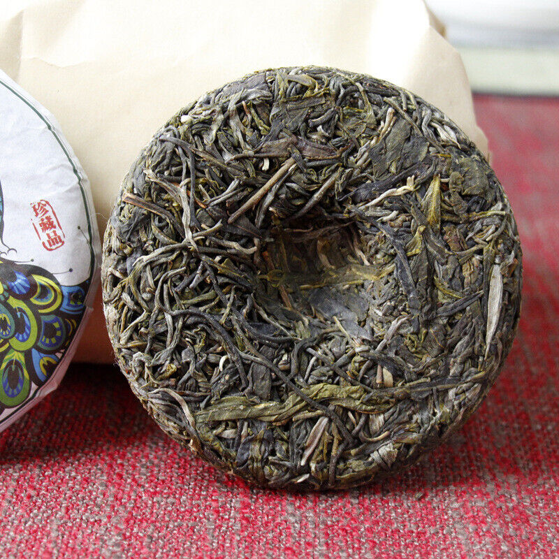 100g Yunnan Pu'er tea Icelandic raw peacock green cake seven cakes Mengku tea