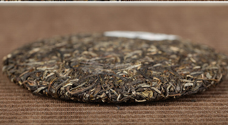 Xiaguan Qian Jia Zhai Wild Aged Old Tree Round Cake Puer Raw Pu'er Tea 357g